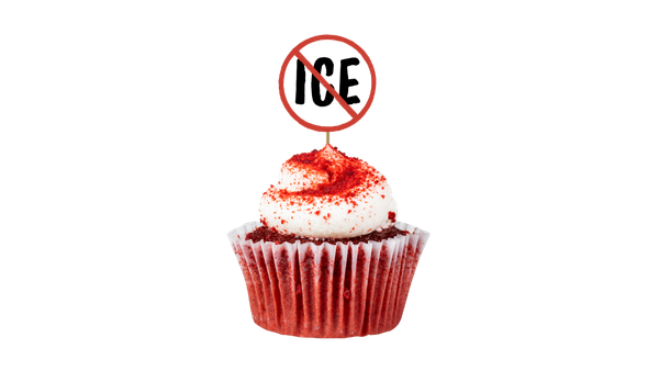 A close-up photo of a red velvet cupcake with white frosting and red sugar sprinkles, decorated with a toothpick flag with bold "ICE" text inside a red prohibition circle (no symbol)